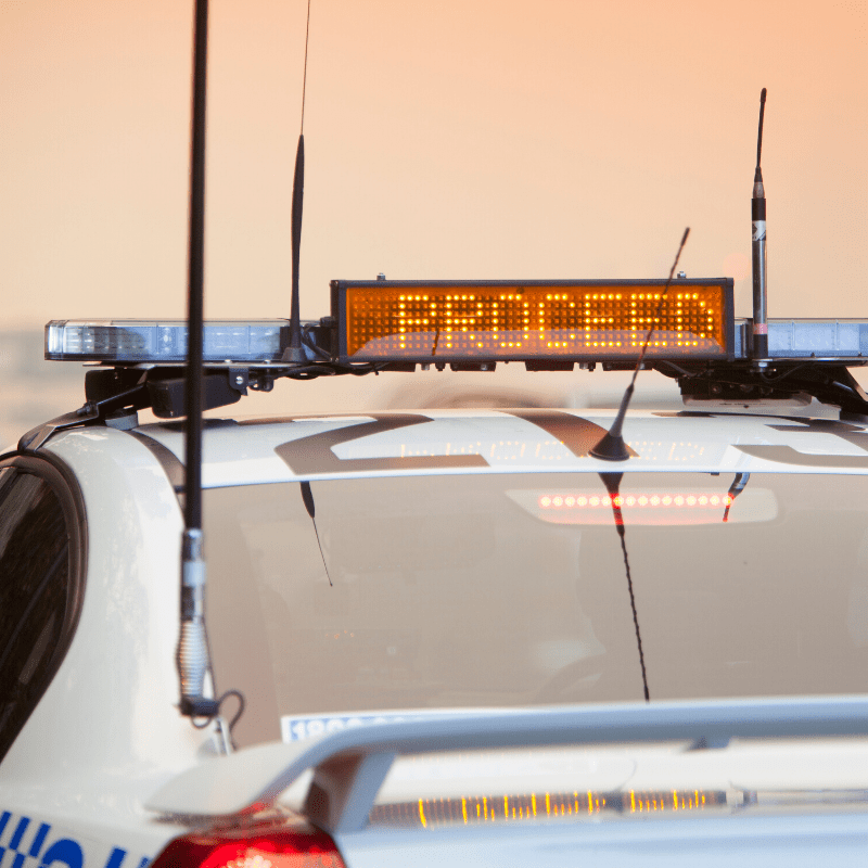 Traffic police car in NSW warning drivers to be cautious with a flashing sign that says ”Proceed”